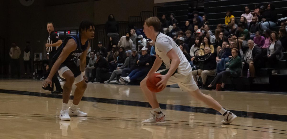 Number 24, Adyn McGinley dribbling against a defender.