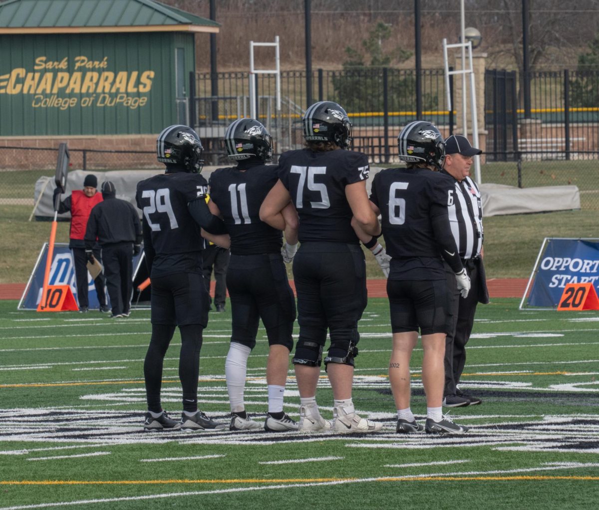 Freshman wide receiver Clayton Bone, sophomore offensive line Greg Fotinopoulos, freshman linebacker William Sierra, and freshman defensive back Mason Montgomery walk onto the field 