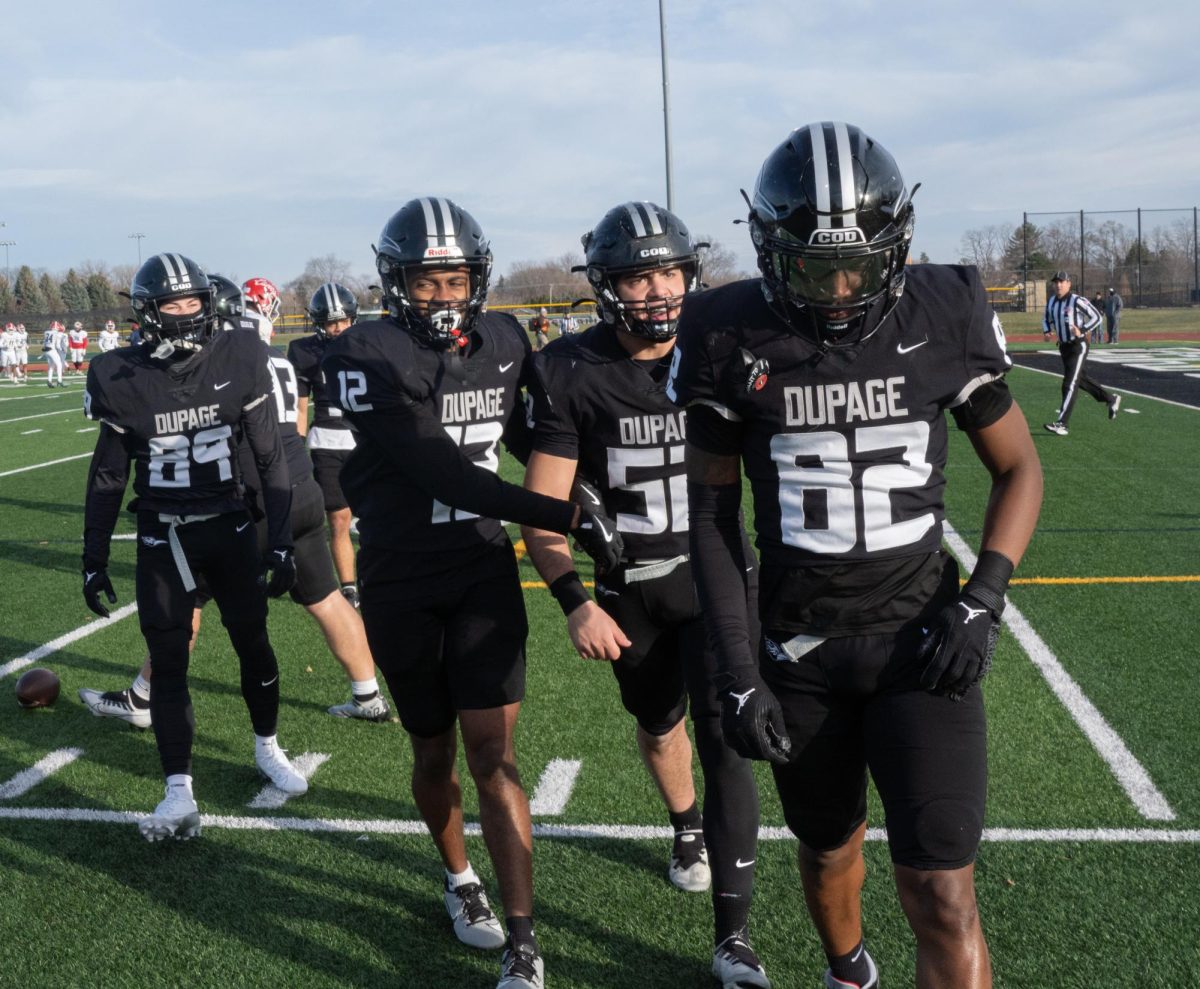 The COD football team celebrates on the sidelines. 