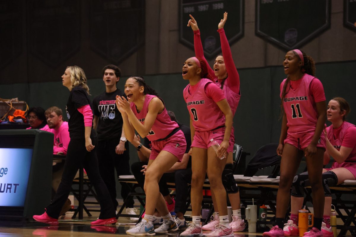 The COD women's basketball team cheers on the sidelines