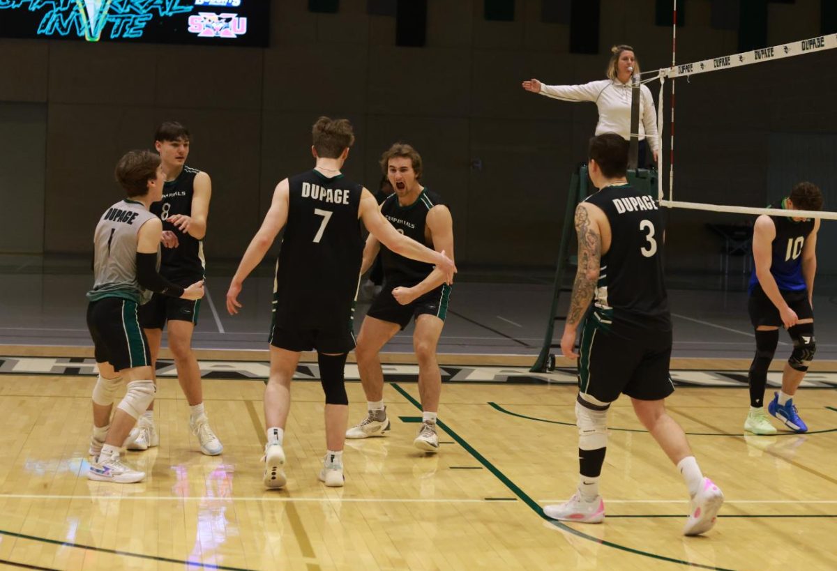 The COD men's volleyball team celebrates after scoring. 