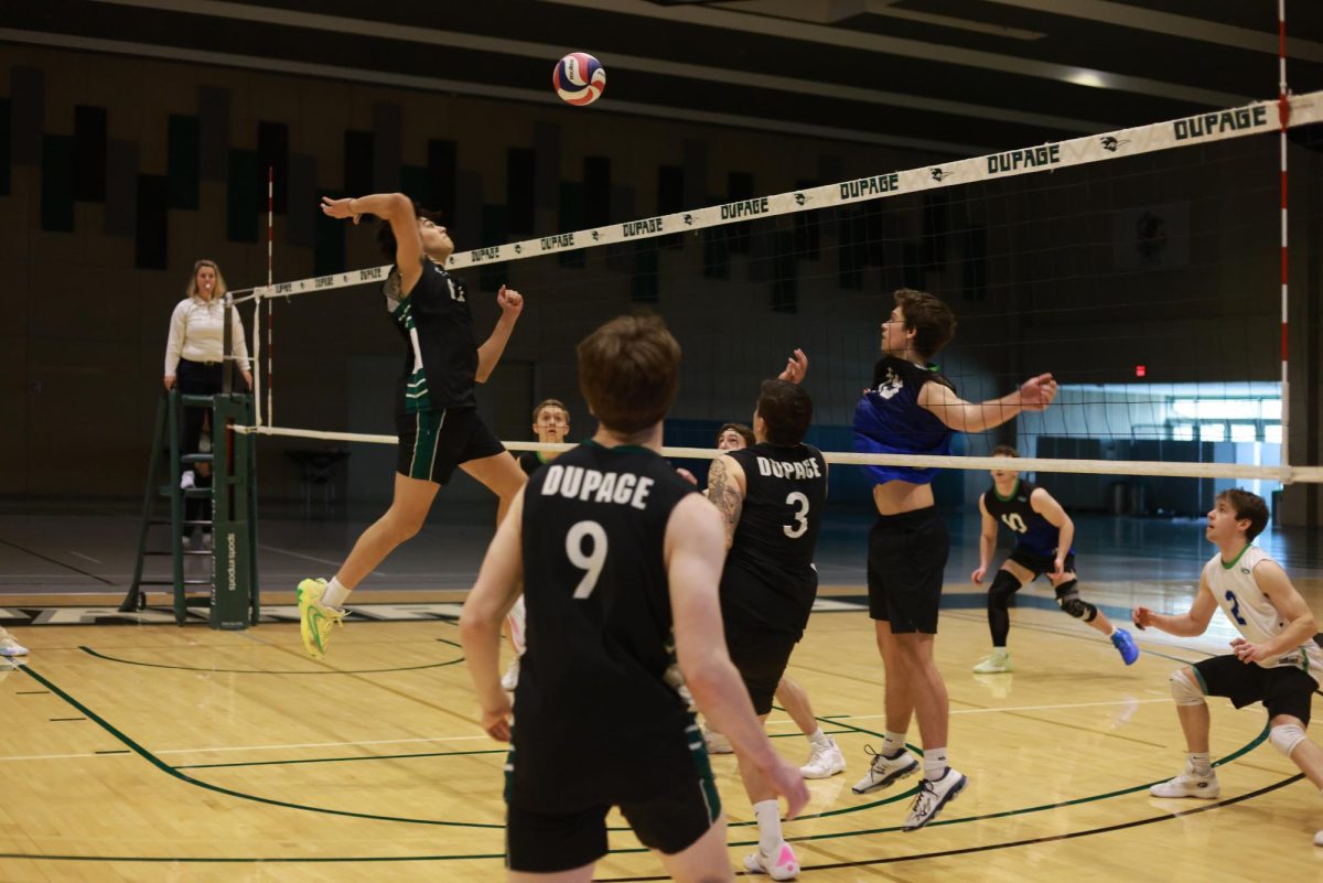 Freshman middle hitter Brayden Tejeda jumps to spike the ball. 