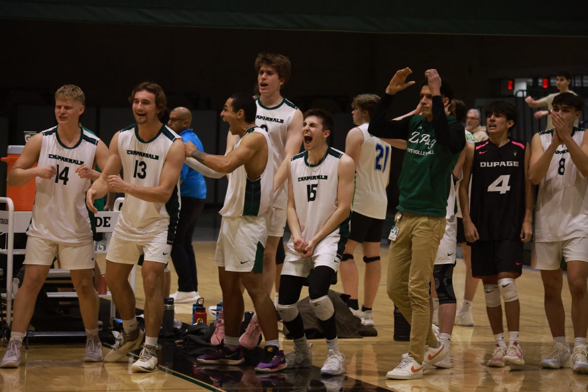 The COD men's volleyball team celebrates after scoring. 