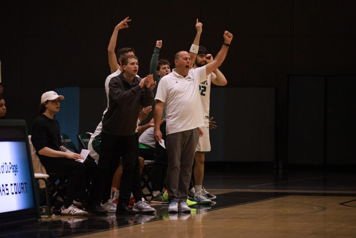 The COD men's basketball team cheers from the sidelines. 