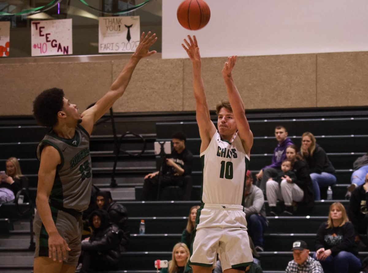 Freshman guard Payton Moore shoots a three point shot. 