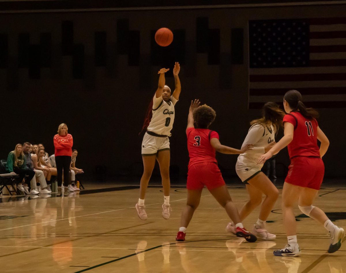 Number 0, Jaylen Zachary jumps for a throw at the basket.