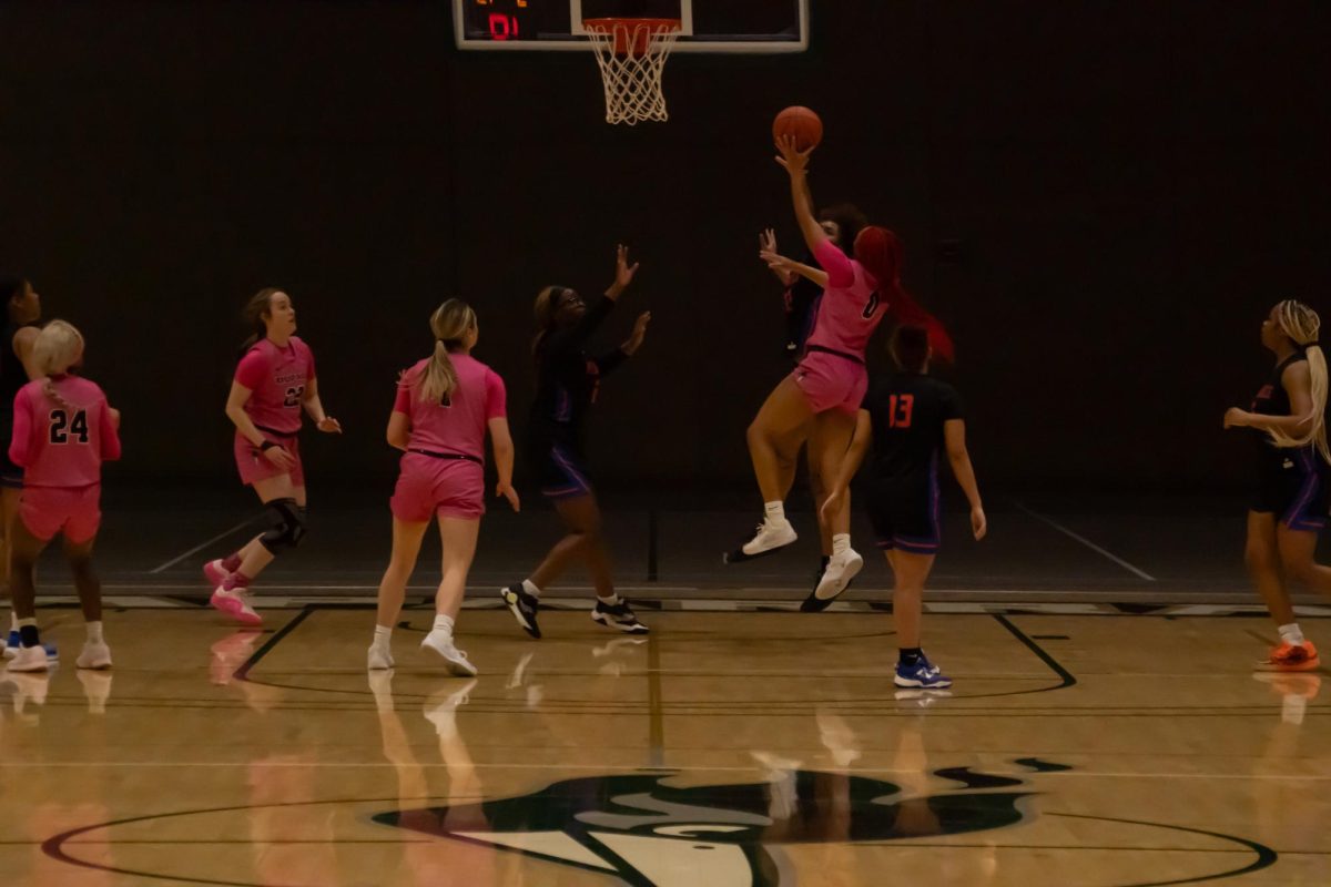 Number 0, Jaylen Zachary jumping at the basket.