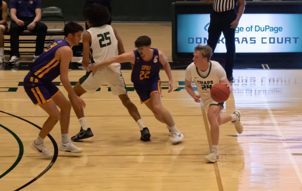 Number 24, Adyn McGinley dribbling the ball in the game against Olivet Nazarene JV game.