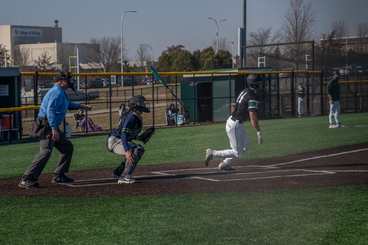 Number 14, Zach Glidewell throwing his bat after hitting a pitch.
