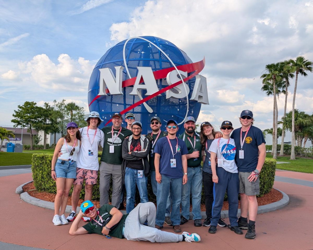 COD Engineering Club students posing with NASA sign at the Kennedy Space Center in Florida (photo courtesy of Grayson Arendt).