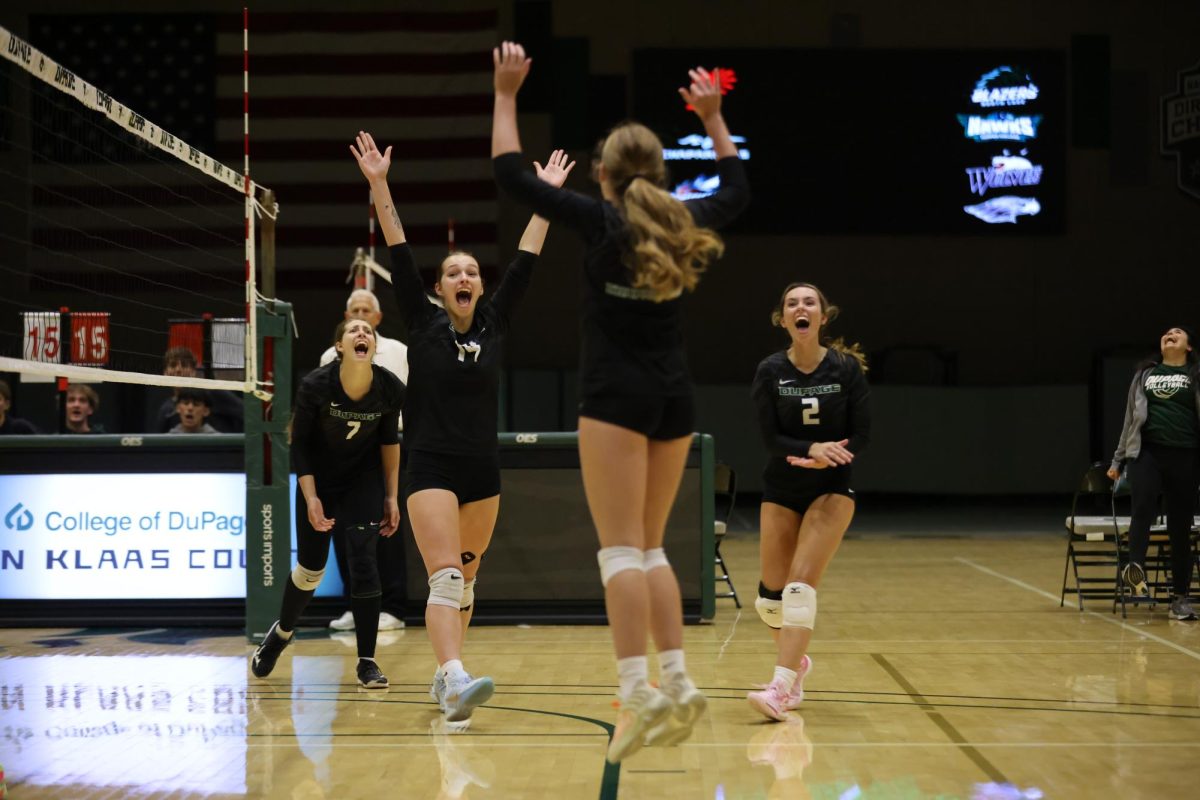 The College of DuPage women's volleyball team celebrates after earning a point. 