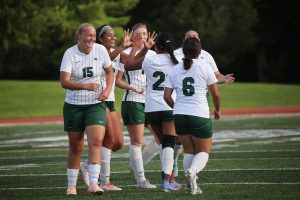 The College of DuPage women's soccer team celebrates after scoring a goal. 