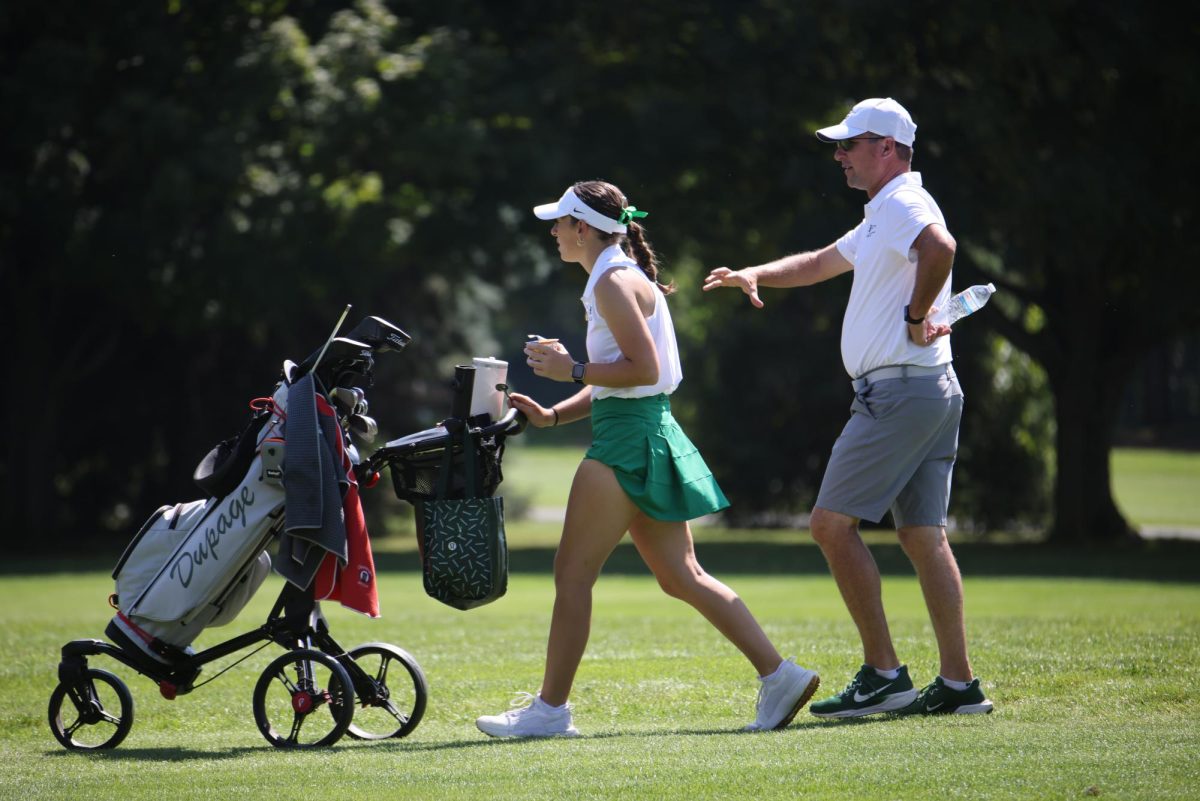 Aubreye Hyatt walks with head coach Jason Hyatt. 
