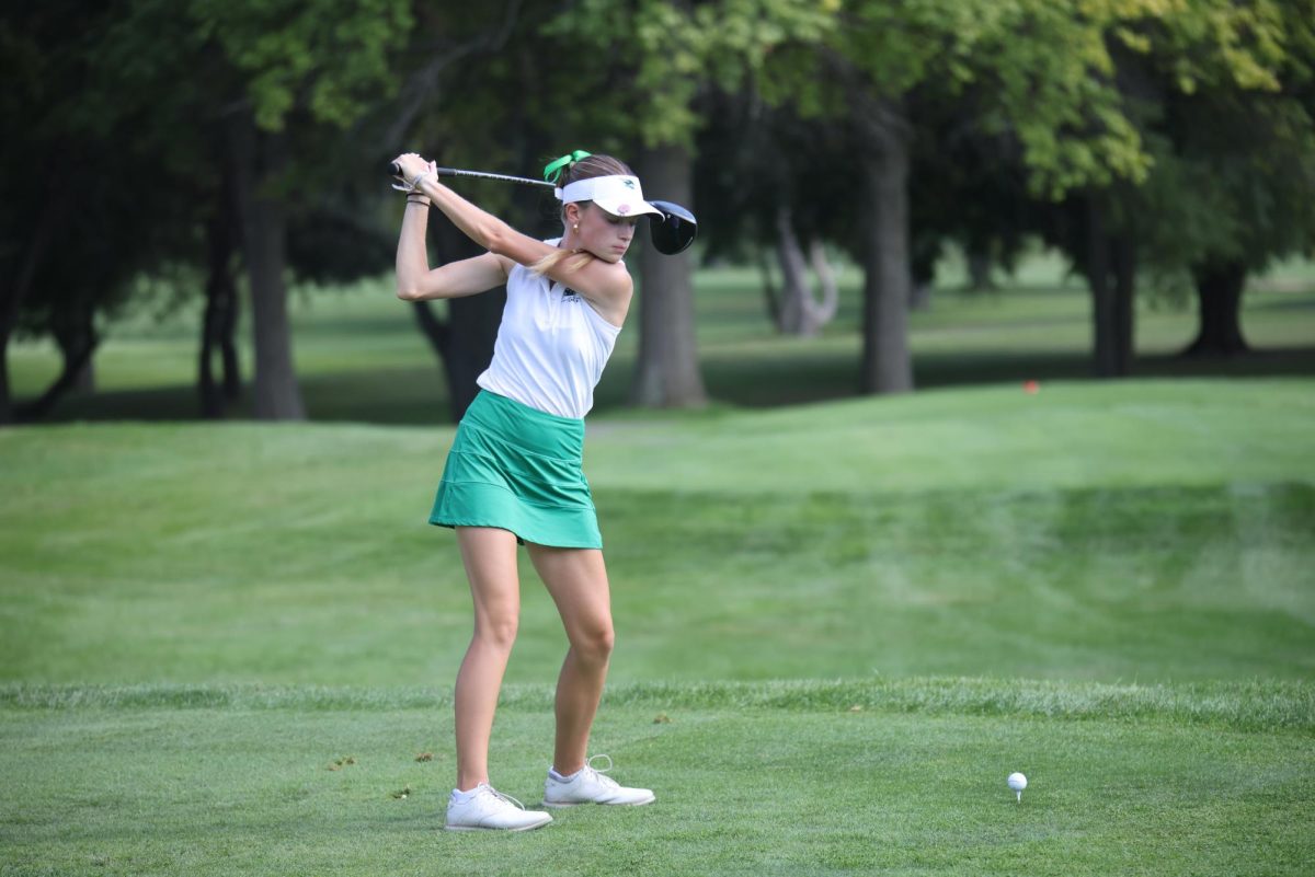 Isabella Krosse winds up her club before swinging the ball.
