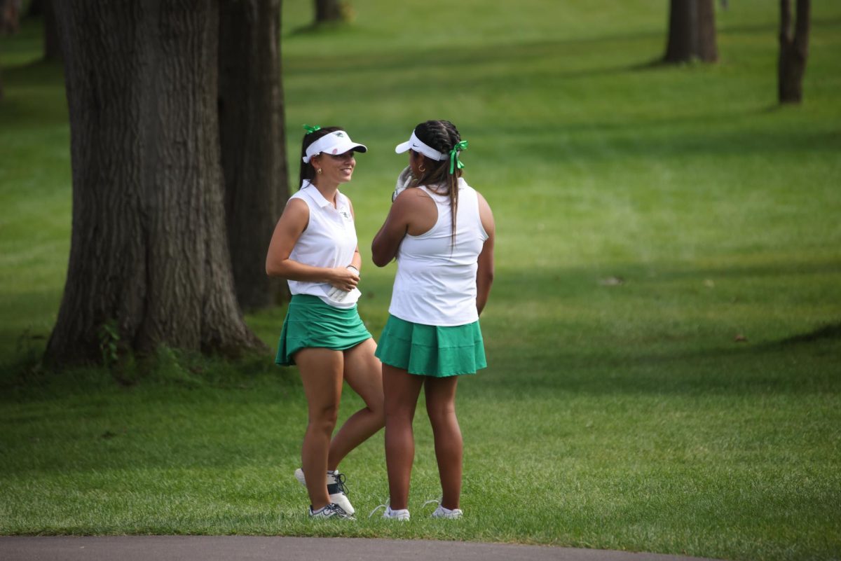 Maryssa Zielinkski and Liliana Martinez talk on the course. 