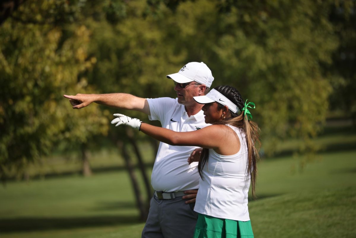 Head Coach Jason Hyatt talks with Liliana Martinez.
