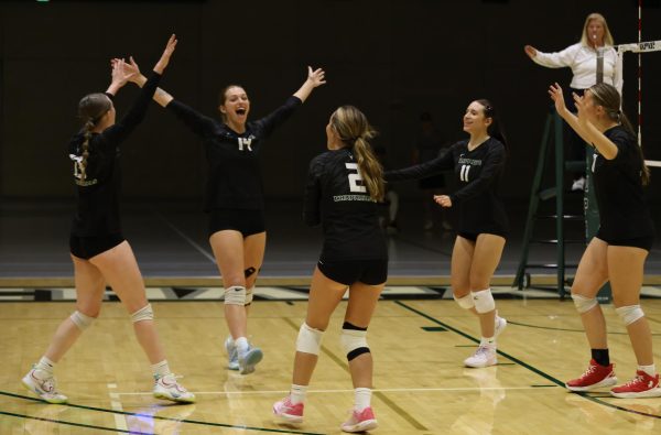 The College of DuPage women's volleyball team celebrates after earning a point. 