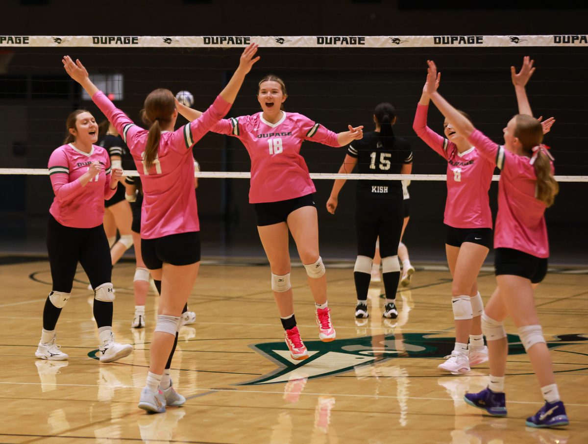The COD volleyball team celebrates after earning a point.