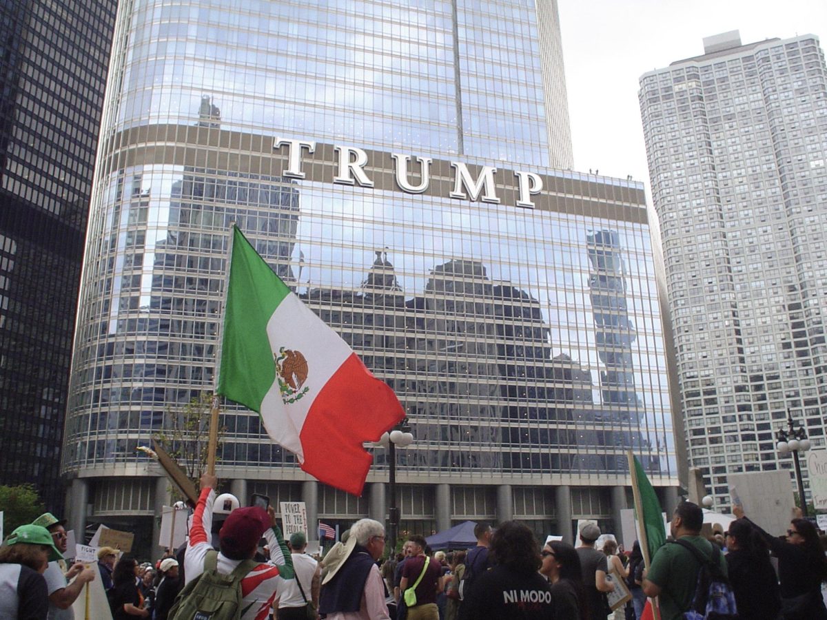 A protester waving the Mexican flag outside of Trump Tower.