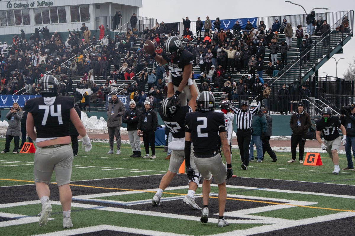 Nick Cairo lifts up AJ Moore after he scored a touchdown. 