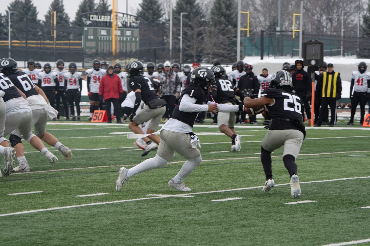 Justin Bland hands off to AJ Moore.