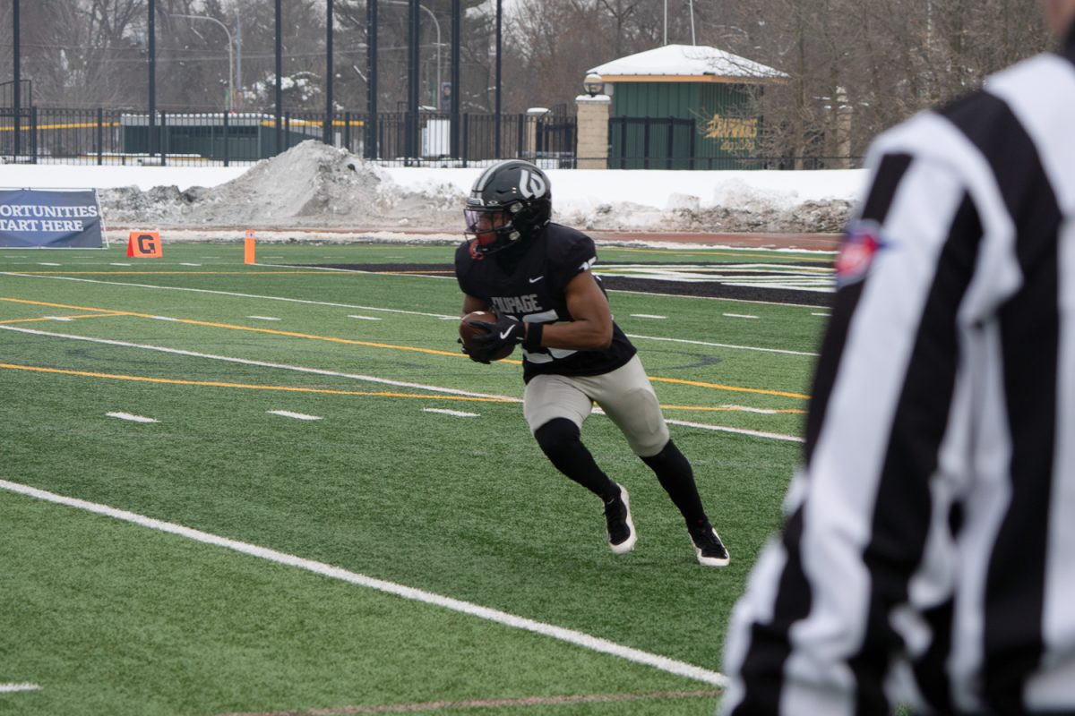 AJ Moore carries the ball. 