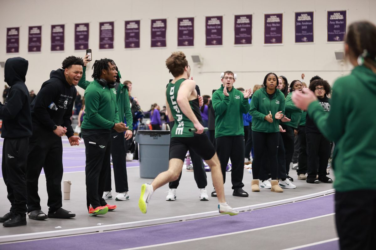 The track team cheers during the 4x400-meter relay. 