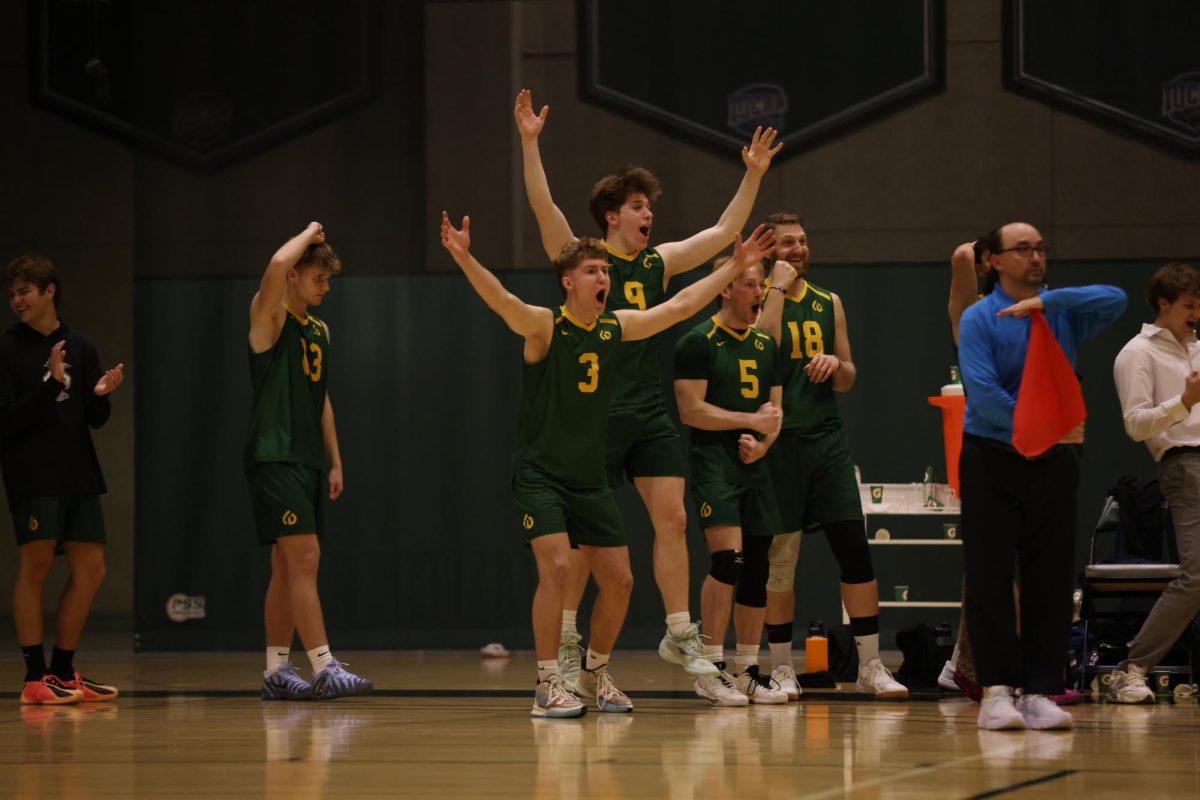 The COD volleyball team celebrates after scoring a point. 