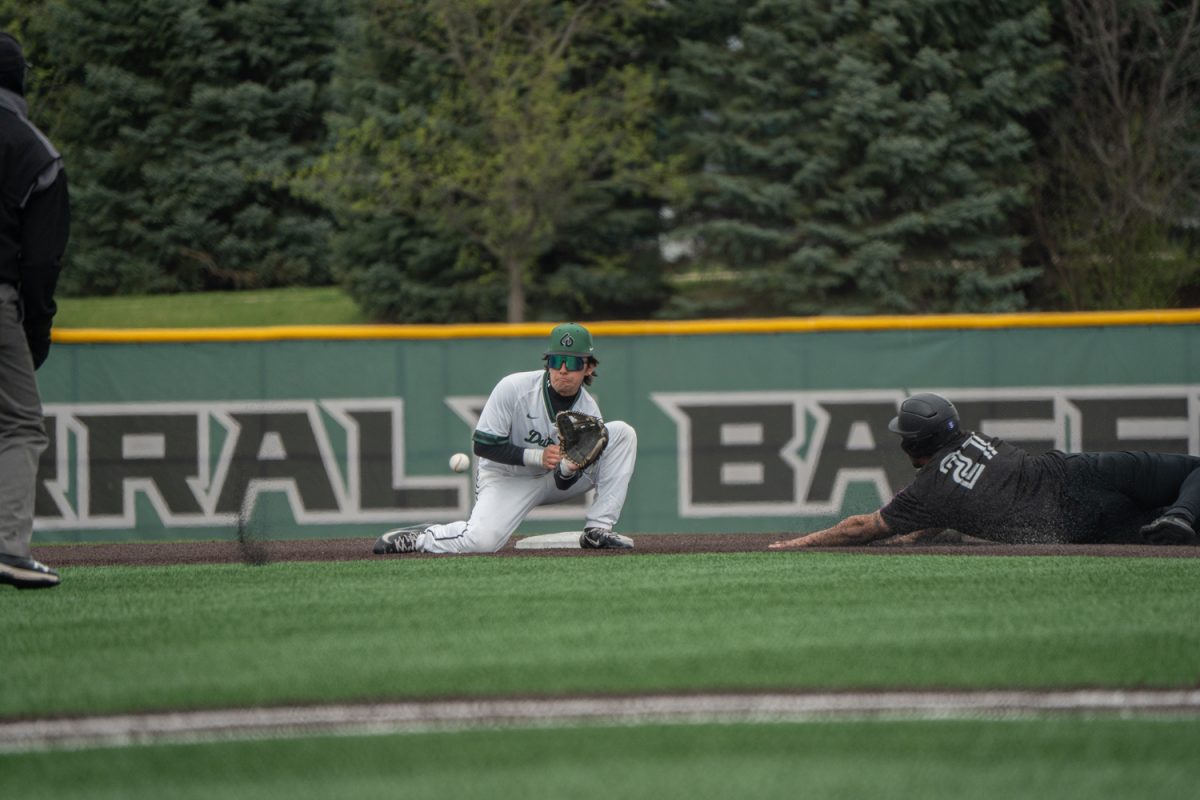 Number 16, Rocco Luciano on the ground getting ready to make a player while a Panther player is sliding into second.