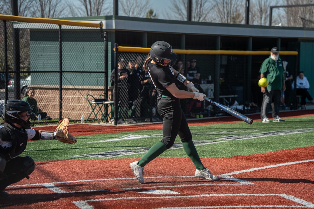 Number 9, Olivia Vasak hitting the softball.
