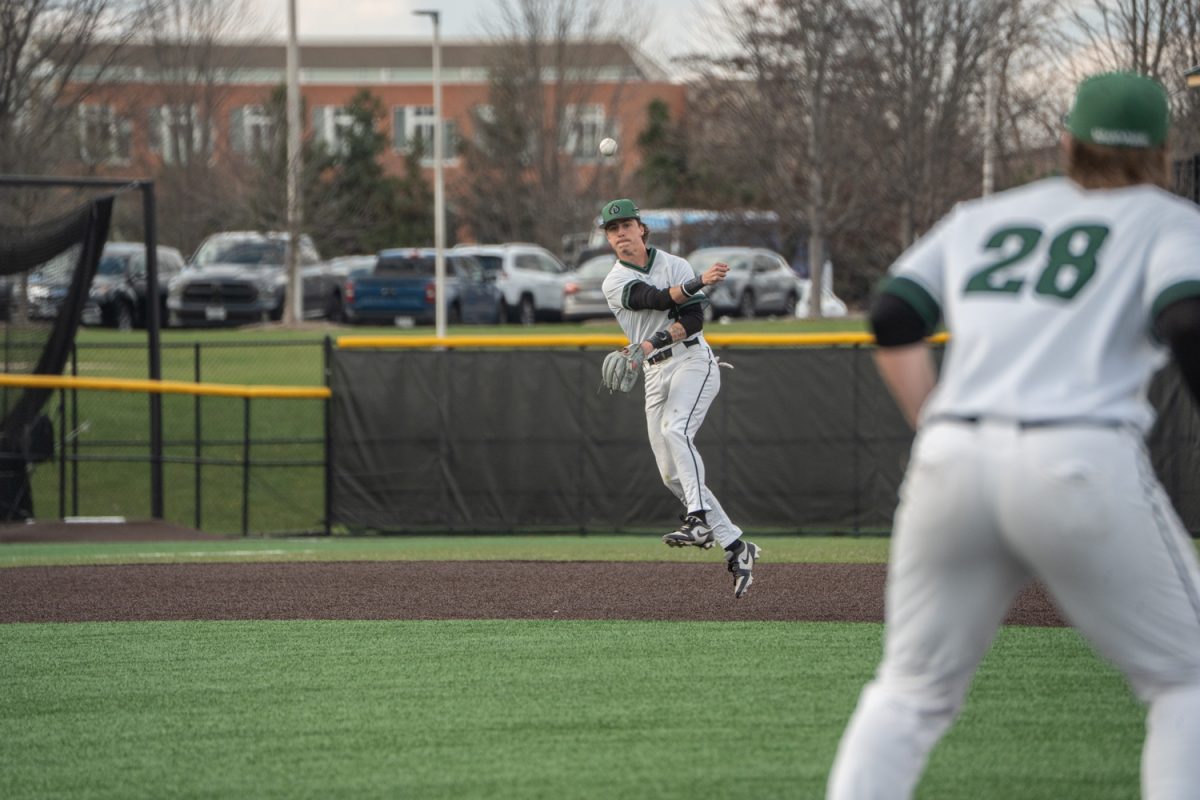 Number 4, Hudson Williams jumping and watching the ball after throwing it to first.
