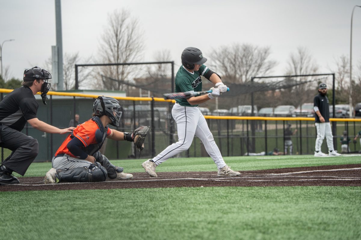Number 20, Rocco Damato swinging his bat at a pitch.
